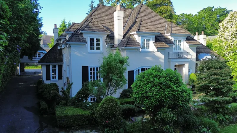 Weathered cedar shake roof before replacement — French-style estate, front elevation